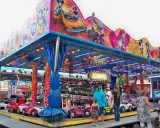 Attraction for children with cars, decorated with Mickey Mouse and friends. A sign says "Paris Dakar".
