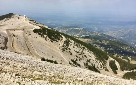 Vue panoramique depuis le sommet du Mont Ventoux, avec ses routes sinueuses et les **villes sur Auze** lointaines.