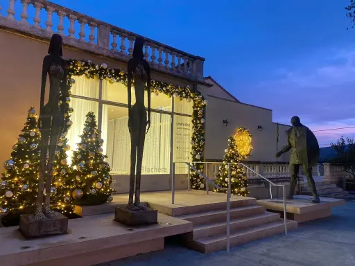 Sculptures et sapins illuminés devant la Fondation Blachère, ambiance festive au crépuscule.